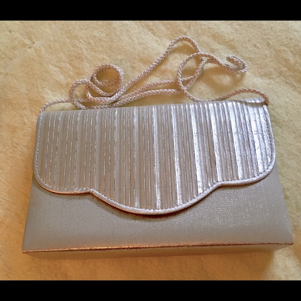 VINTAGE SILVER CLUTCH W/SILVER SATIN ROPE SHOULDER STRAP. Elegant and timeless